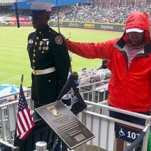 Baseball Fan Holding Umbrella Over JROTC Member On Memorial Day